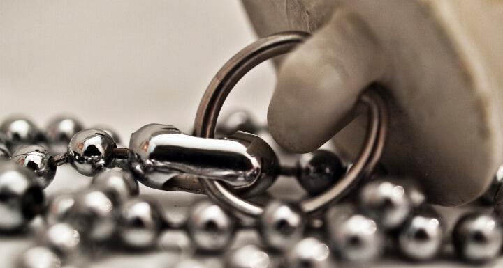 Sink plug attached to a chain