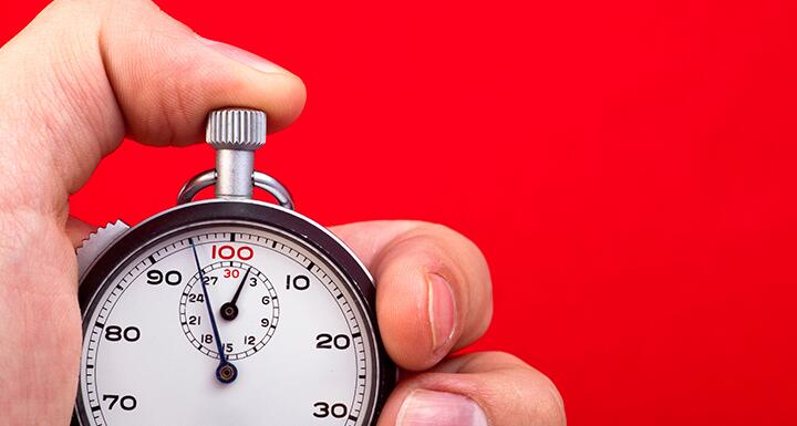 Thumb on stop watch button with red background