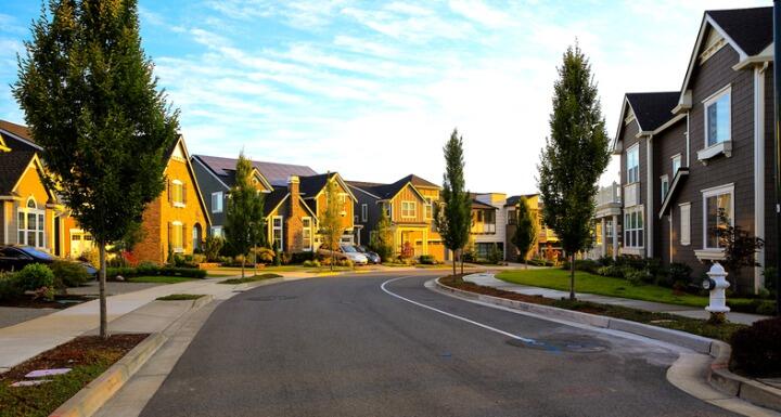 Neighborhood of homes with sun shining on the homes