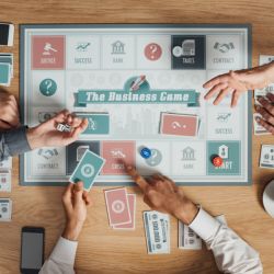 Business people playing a board game