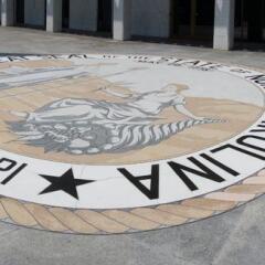 The front entrance of the NCGA with-state-seal-and-motto
