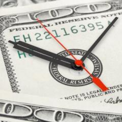 Clock face on 100 dollar bill signifying time is money