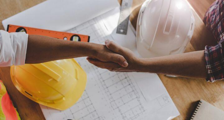 Top view of construction worker team contractor hand shake after finishing up business meeting