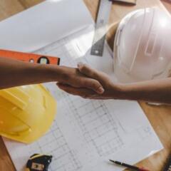 Top view of construction worker team contractor hand shake after finishing up business meeting