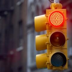 Traffic light on street with red signal lit up