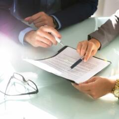 Two business people analyzing a document