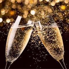 Two glasses of champagne toasting in the night with lights bokeh