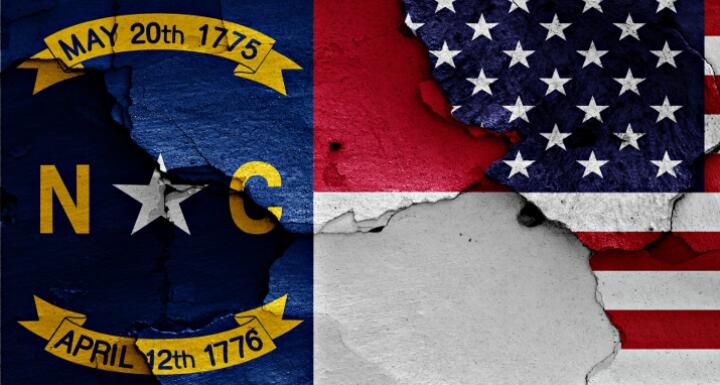 North Carolina and American flags painted onto cracked wall