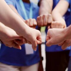 A group of volunteers joing hands in a circle