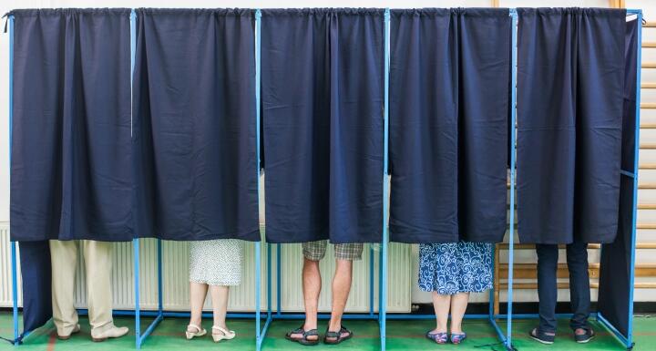 People in voting booth