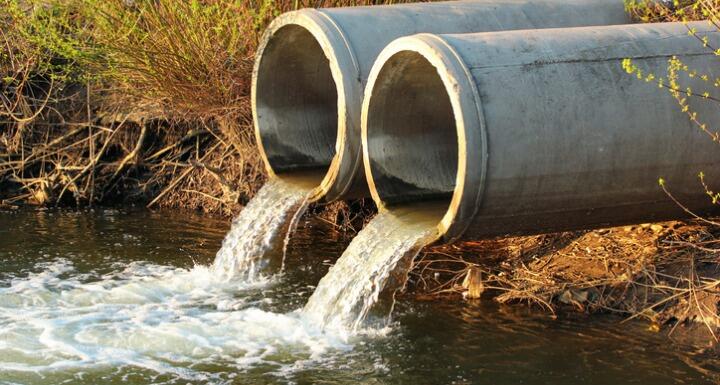 Two cement water pipes discharging water