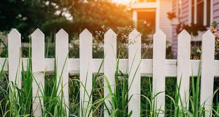 White wooden fence in suburban neighborhood