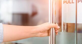 Woman pulling on door handle