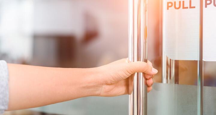 Woman pulling on door handle