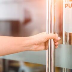 Woman pulling on door handle