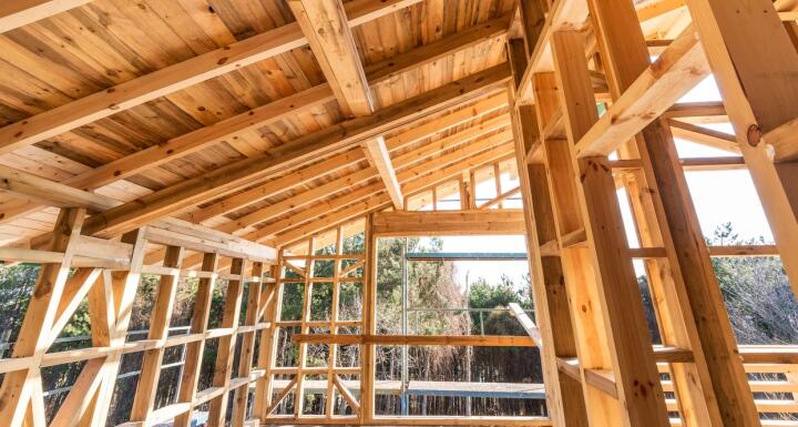 Inside a room under construction with the wooden beams exposed