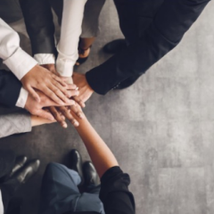Group of people putting hands in