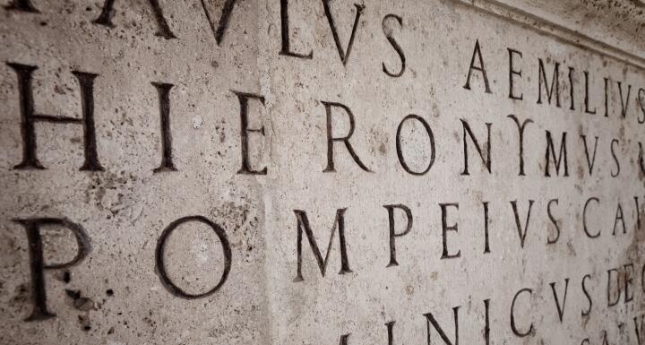 A stone carving of latin words