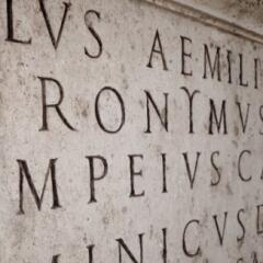 A stone carving of latin words