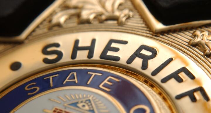 Gold sheriff badge