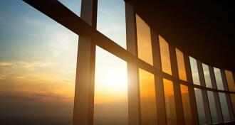 Curving windows in an office building with sunlight coming through