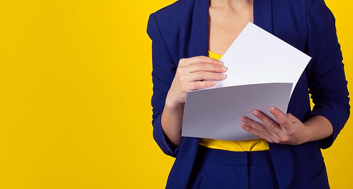 Woman in blue suit shifting through papers