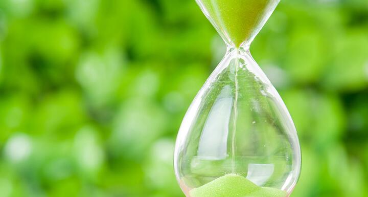 Hour glass with green sand