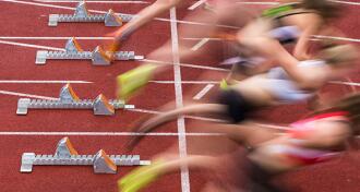 runners taking off at starting line