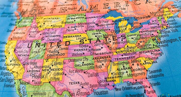 Globe view of the United States with states colored in yellow pink orange and green
