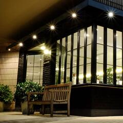 Sidewalk view of a brightly lit closely held plant business