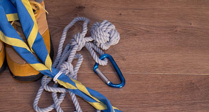 boy scout scarf, hiking boots, and other equipment on a tablre