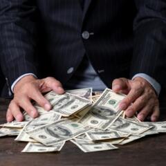 Businessman sweeping money