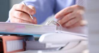 Close-up of male hands signing important business document