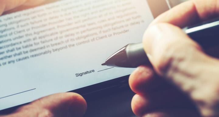 man sign distance contract with digital pen in mobile phone