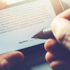 man sign distance contract with digital pen in mobile phone