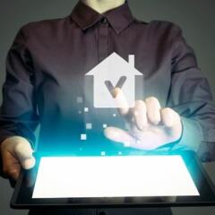 girl with tablet in her hands, checking house icon