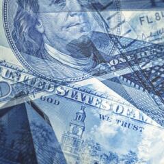  hundred dollar bills on top of downtown buildings