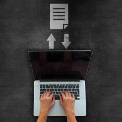 laptop on blackboard with document icon