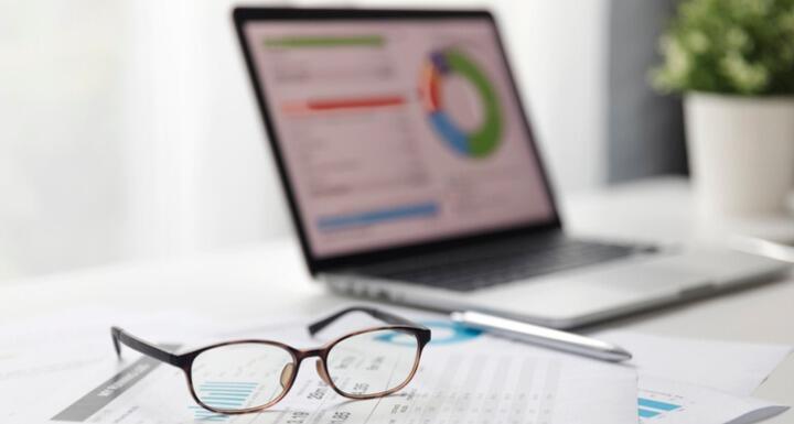 A laptop and glasses on desk