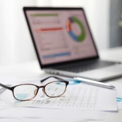 A laptop and glasses on desk