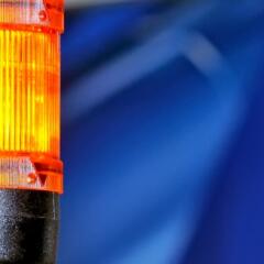 Yellow caution light on blue background