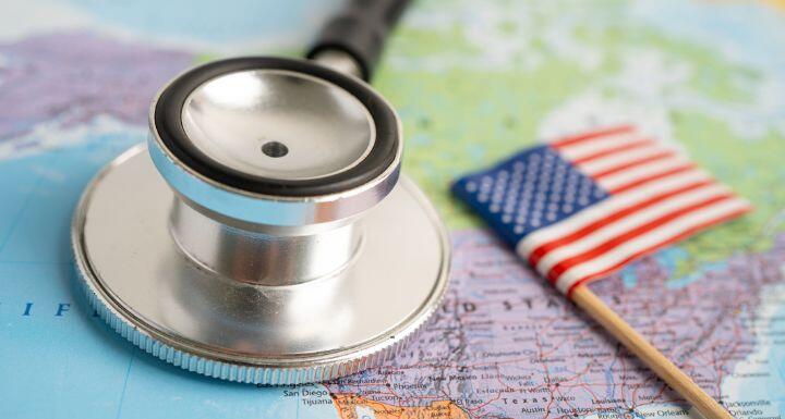 stethoscope with USA America flag on world map background