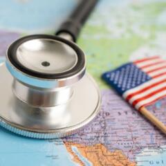 stethoscope with USA America flag on world map background