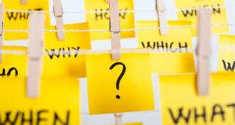 sticky notes with question mark and w questions hanging on the rope