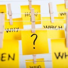 sticky notes with question mark and w questions hanging on the rope