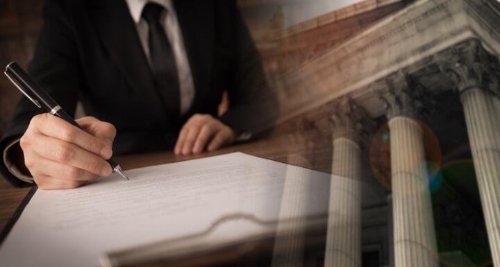 Attorney in a business suit writing on a document