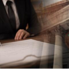 Attorney in a business suit writing on a document