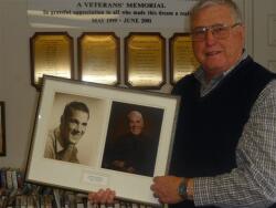 Pete Madsen holds portraits of his old friend and the Vass Area