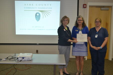 Ashe County Community Foundation Grants Chair Karen Powell presents a grant award to Second Harvest Food Bank of Northwestern North Carolina staff.