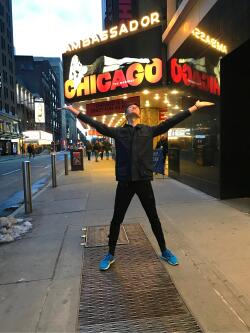 William Brickhouse poses in front of a sign for the iconic production “Chicago.”